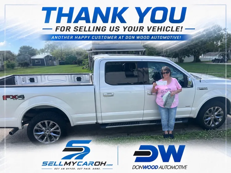 Customer with her check after selling a white Ford F-150 FX4 to Don Wood Automotive
