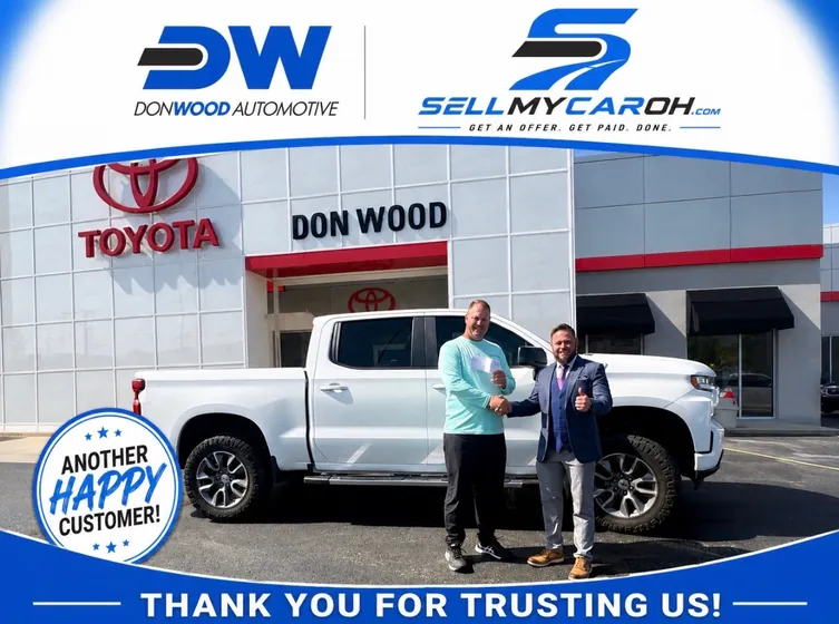 Seller shaking hands after selling his white Chevy Silverado at Don Wood in Athens